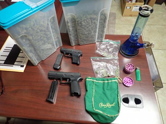 Officers found more than a pound of marijuana and two guns