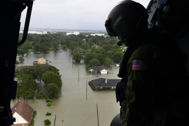 A Coast Guardsman looks out of a helicopter during search and rescue missions following Hurricane Harvey around Beaumont, Aug. 30, 2017. Coast Guard photo by Petty Officer 3rd Class Brandon Giles.