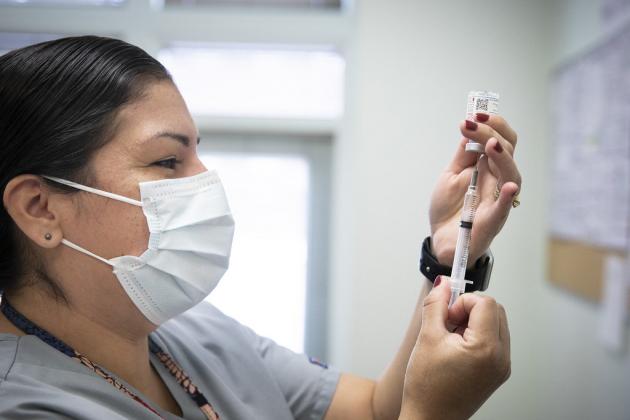 A photo of a nurse preparing a COVID-19 vaccine dose.