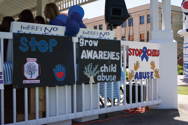 Child Abuse Prevention Month posters adorn the gazebo beside the Beaumont Fire Museum