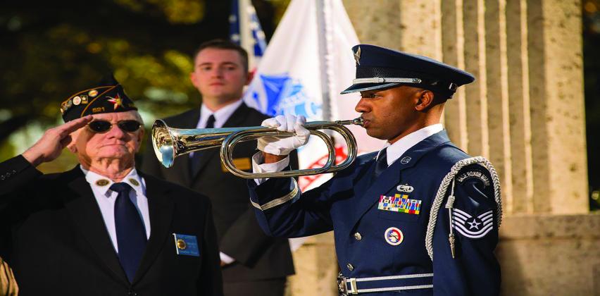 A solider plays a bugle at a Memorial Day ceremony. 