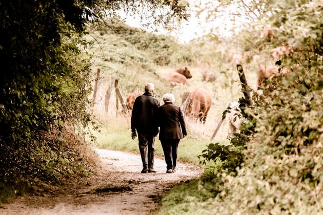 An elderly couple walks together 