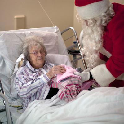 Santa with an elderly woman in bed 