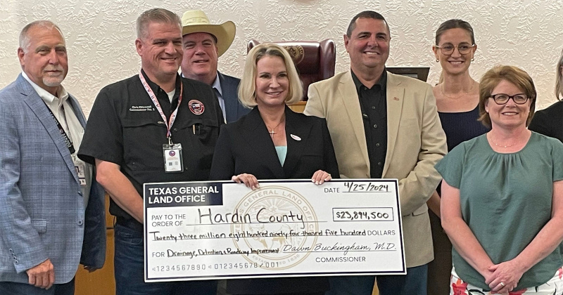 GLO Commissioner Dr. Dawn Buckingham hands Hardin County officials a $23.9 million check.