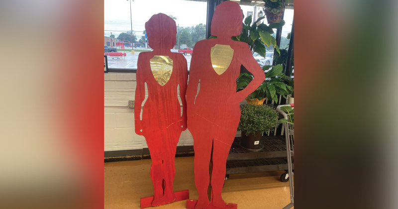 Two wooden silhouettes stand in the lobby of Brookshire Bros. in Lumberton