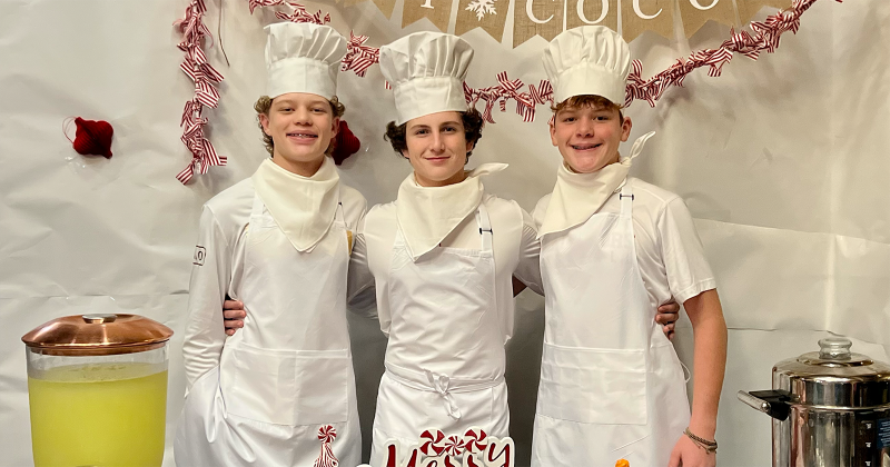 After years of watching their mothers organize the Jefferson County Adoption Day celebration, Lumberton High School freshmen (left to right) Evan Jenkins, Madden Dean and Graham Jenkins put on their aprons and chef hats, embracing their roles as supporting cast members in The Polar Express.