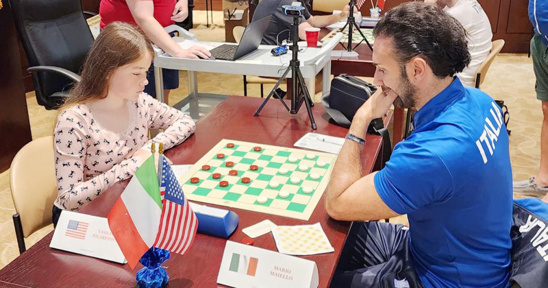 Vasilisa Filaretova, left, of Team USA, and Mario Maiello, of Team Italy, engage in a serious game of checkers. 